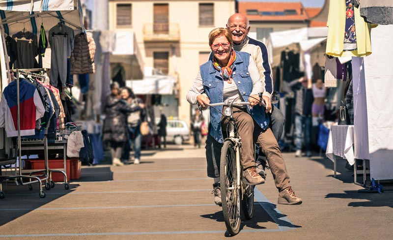 aged couple riding a bicycle