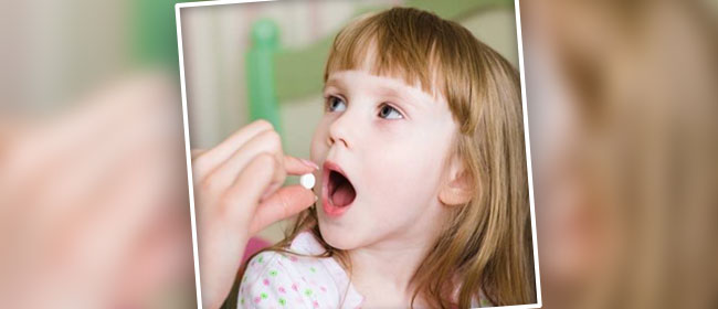 pediatrician administering antibiotics to a child