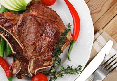 grilled meat dish on a wooden table