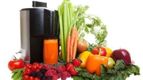 juicing machine with fruits and vegetables