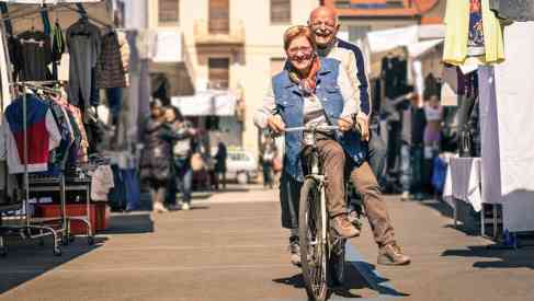 aged couple riding a bicycle