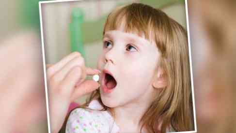 pediatrician administering antibiotics to a child