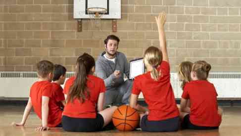 coach and players team talk on gym